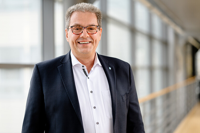 Ralf, Teamleiter Kundenberatung GVV Direkt, lacht breit in die Kamera